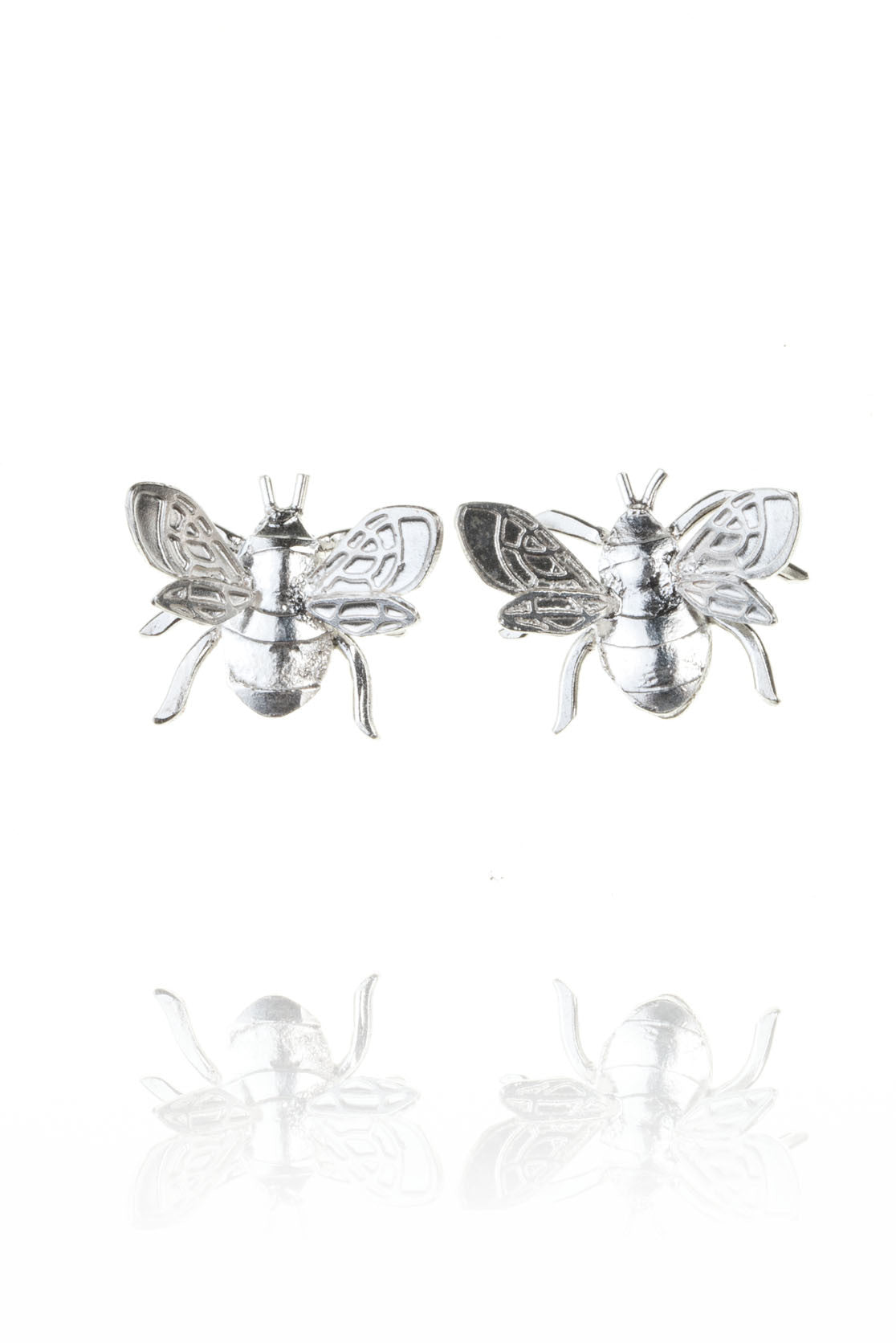 Dainty bee stud earrings handmade in sterling silver on white background