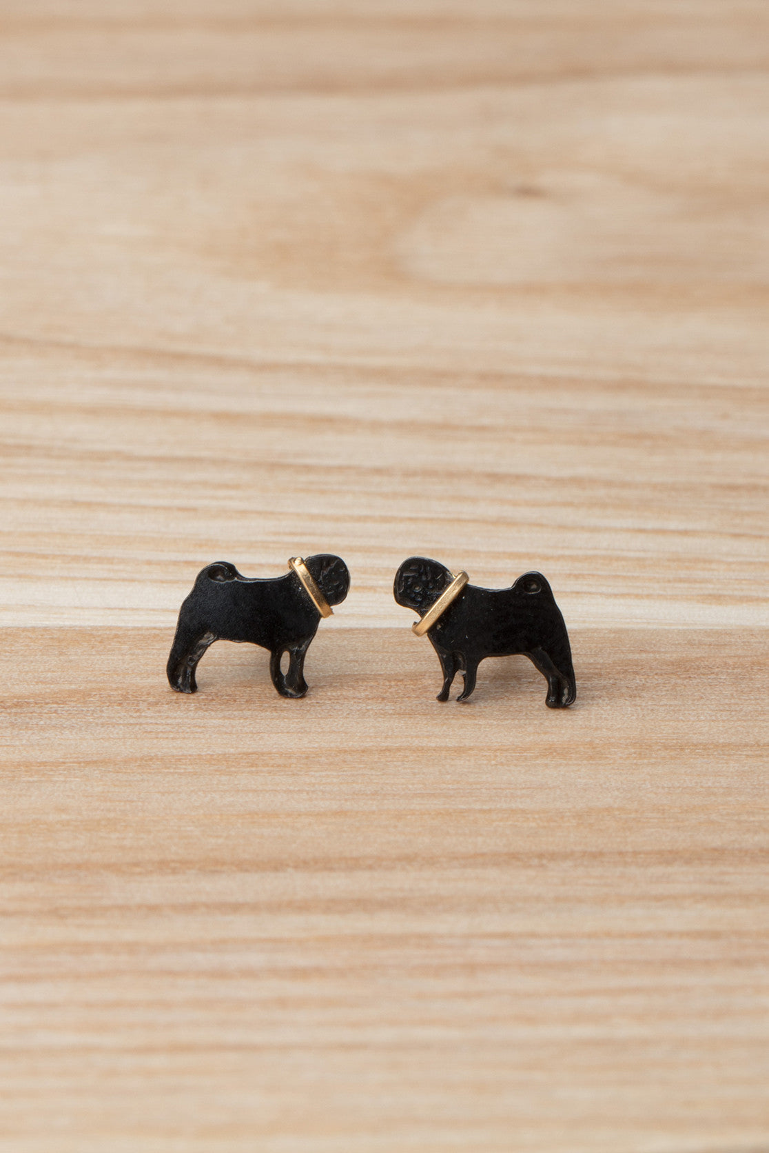 Black pug stud earrings with contrasting gold collar. 