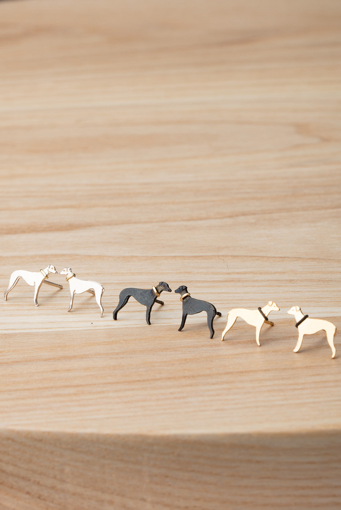 Greyhound stud earrings in silver, gold and black. 