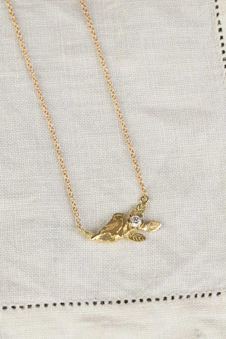 handmade bird and leaf necklace in 18ct gold with diamond