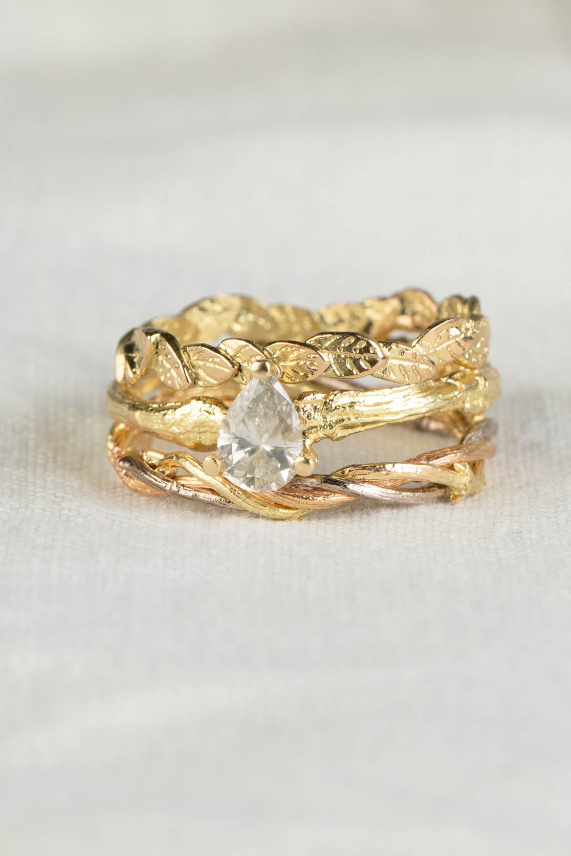stack of handmade 18ct gold rings - leaf ring, twig ring and diamond ring