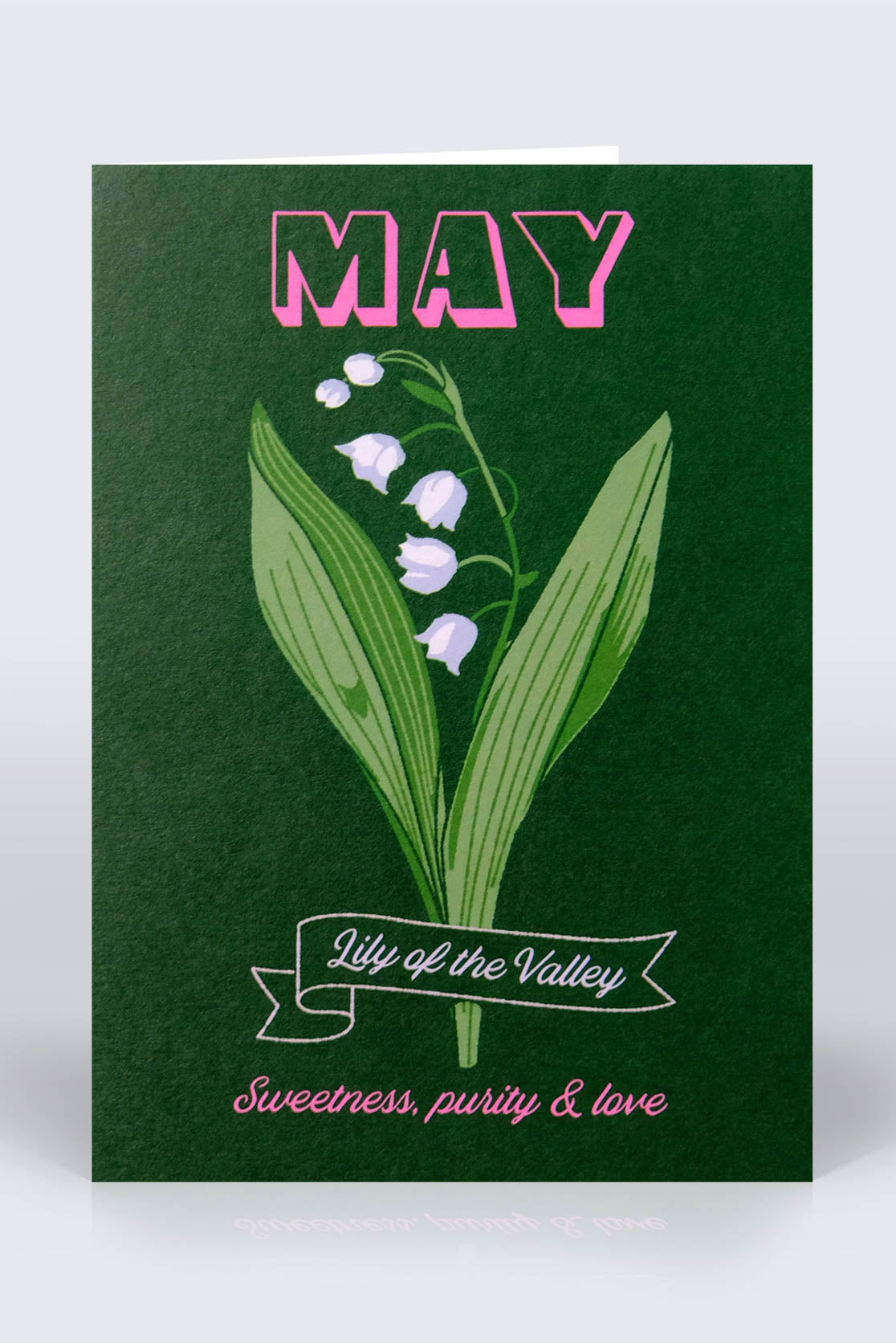 May birthday card on a dark green background with a lily flower on the front cover