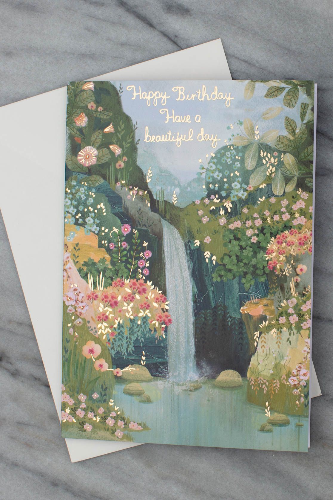 Waterfall and flowers birthday card with a white envelope
