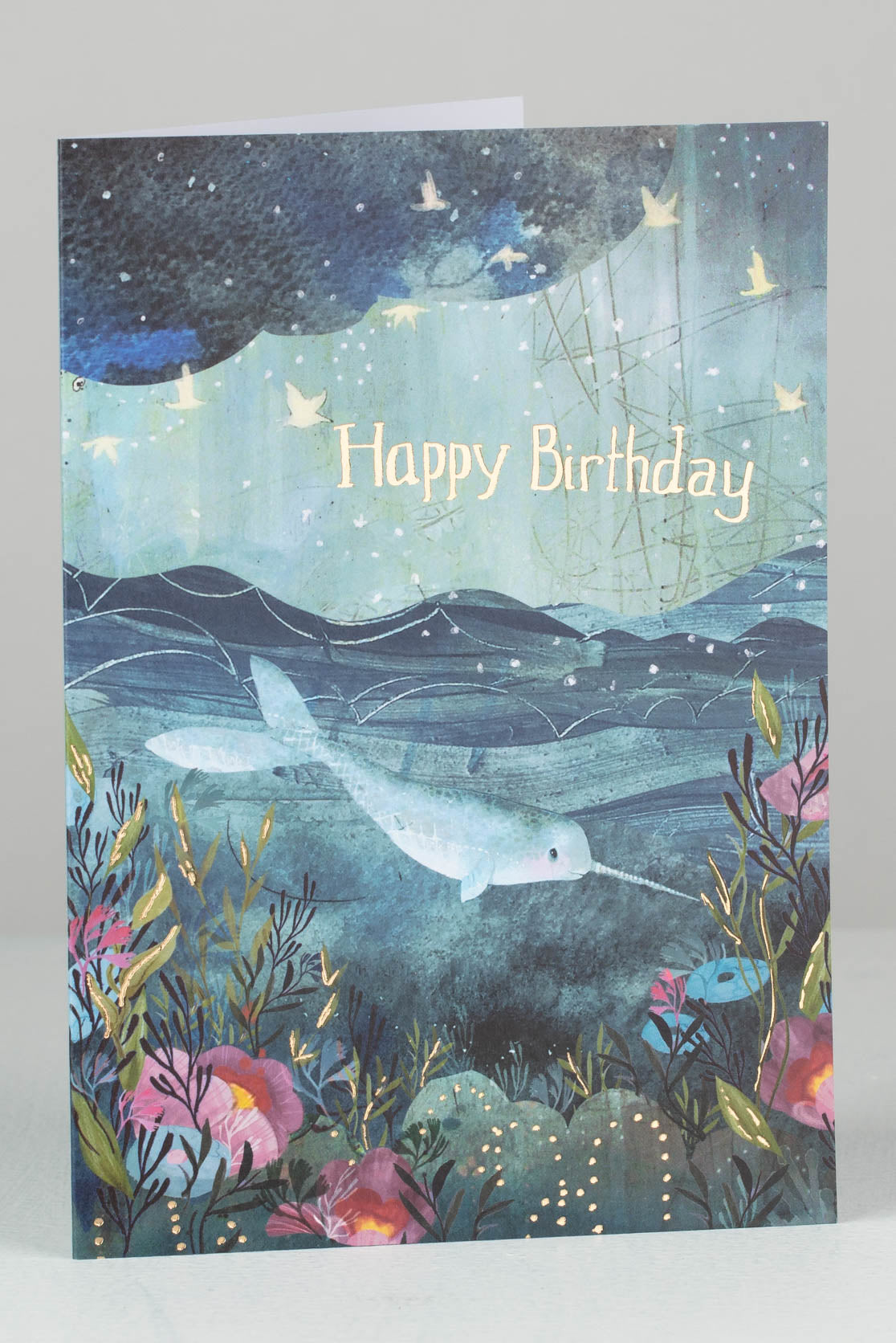 Birthday card showing narwhal in the ocean with seaweed