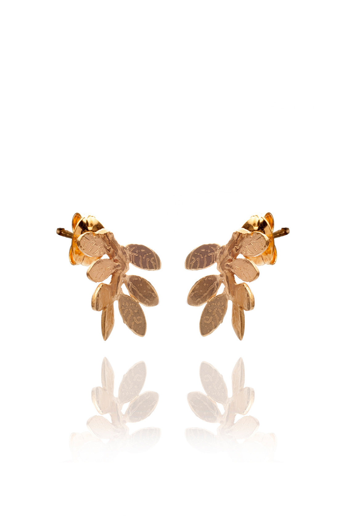 Small yellow gold leaf stud earrings on a white background
